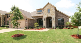 exterior of a model home with a spacious front yard in woodcreek