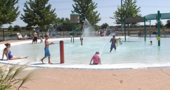 Kids playing on the kids pool playground at Woodcreek