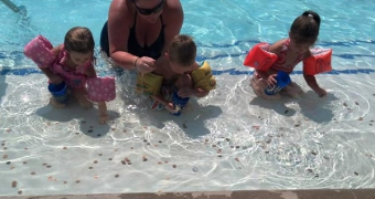 Mom and three children in the pool at Woodcreek