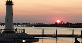 Rockwall Harbor, lighthouse on the water with sun going down