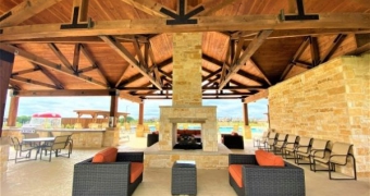 fireplace under pavilion with couches